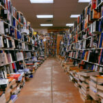 An alley of books with a burnished concrete floor and books rising up the sides.