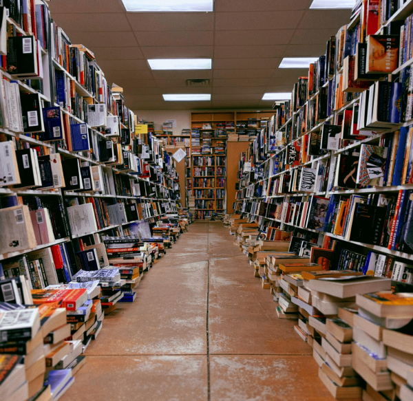An alley of books rising above a burnished concrete floor. 